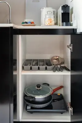 a kitchen with a stove with a pan on it at Great Hill Jungle View Pool Gym Naiyang in Nai Yang Beach