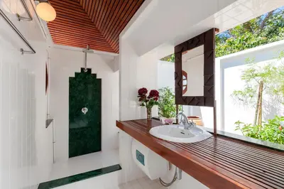a bathroom with a sink and a mirror at Baan Khunying - Secluded Phuket Beachfront Villa in Rawai Beach
