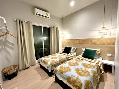 a bedroom with two beds and a window at Surfer House Patong Center 3 Bedrooms in Patong Beach
