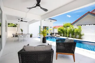 a living room with a swimming pool and a villa at Private Pool Villa Rawai Beach in Rawai Beach