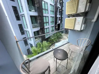a balcony with two chairs and a table at Luxury private apartment Citygate by Lofty in Kamala Beach