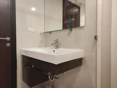 a bathroom with a white sink and a mirror at Rawai beachfront - One bedroom on 3 floor at Title in Rawai Beach