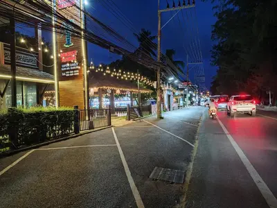 a city street at night with cars driving down the street at Rawai beachfront - One bedroom on 3 floor at Title in Rawai Beach