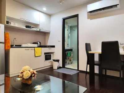 a kitchen with a table and a dining room at Rawai beachfront - One bedroom on 3 floor at Title in Rawai Beach