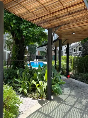 a wooden pergola with a pool in a yard at Title V Pool View 3fl Gym Hammam Rawai in Rawai Beach