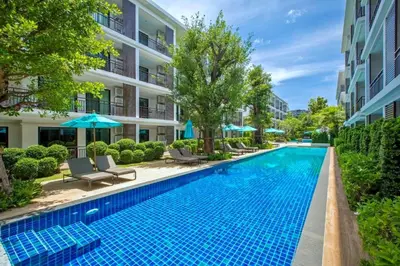 a swimming pool in front of a building at New Apartment TTL B209 in New Rawai Beach Residence with Tropical Pools in Rawai Beach