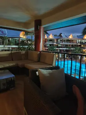 a living room with a couch and a swimming pool at KALIM RESIDENCE unit 132 VUE MER in Patong Beach