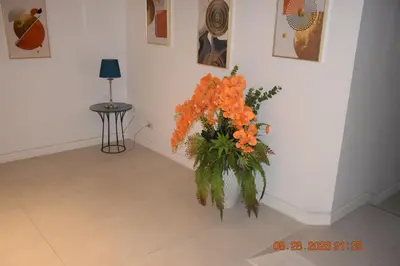 a vase filled with orange flowers in a room at KALIM RESIDENCE unit 132 VUE MER in Patong Beach