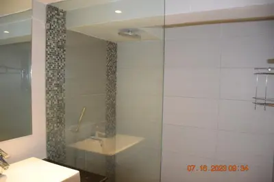 a bathroom with a glass shower and a sink at KALIM RESIDENCE unit 132 VUE MER in Patong Beach