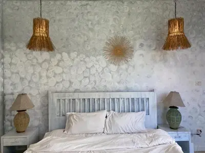 a bedroom with a bed with two night stands and two lamps at TIL DAWN Phuket in Karon Beach