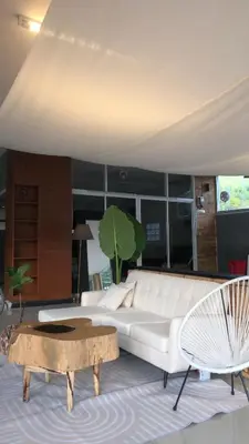 a living room with a white couch and a coffee table at TIL DAWN Phuket in Karon Beach