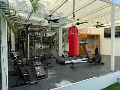 a gym with a fitness center with a punching bag at Beautiful private 4 bedroom villa with pool and gym in Rawai Beach