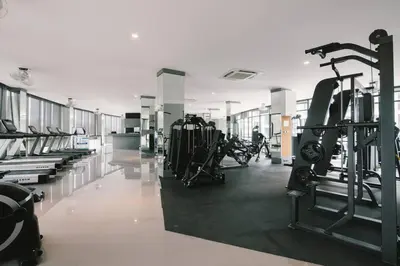a gym with treadmills and machines in a room at Kamala Beach P67 Exclusive Junior Suite in Kamala Beach