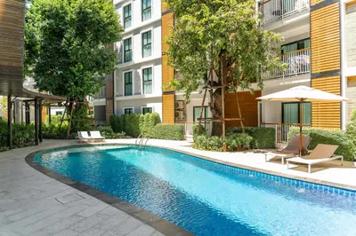 a swimming pool in front of a apartment building at Title V Sunny Holiday Pool View Gym Hammam in Rawai Beach