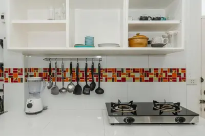 a kitchen with a stove and a counter with utensils at Karon Beach Holiday Home 1 in Karon Beach