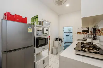 a kitchen with a stainless steel refrigerator at Karon Beach Holiday Home 1 in Karon Beach