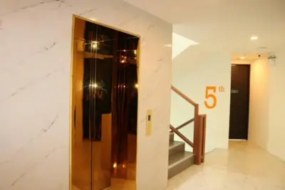 a hallway with a elevator and stairs in a building at Oceana Resort Kamala Ocean View 5th floor in Kamala Beach