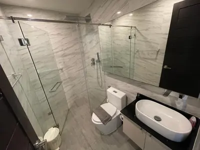 a bathroom with a shower and a toilet and a sink at Oceana Resort Kamala Ocean View 5th floor in Kamala Beach