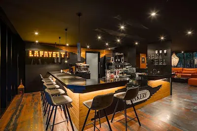 a bar with a bunch of stools in a room at Kamala Beach P55 Exclusive Junior Suite in Kamala Beach