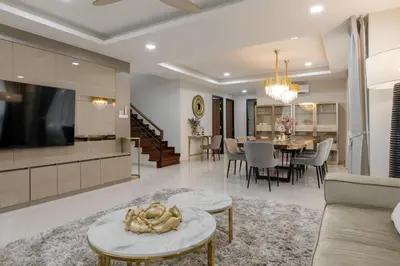 a living room with a couch and a dining room at Modern villa with pool close to the beach - LP #97 in Phuket Town