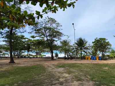 a park with trees and a street light on the beach at Nai Harn beach - Studio room on 2 floor at ReLife The Windy in Rawai Beach