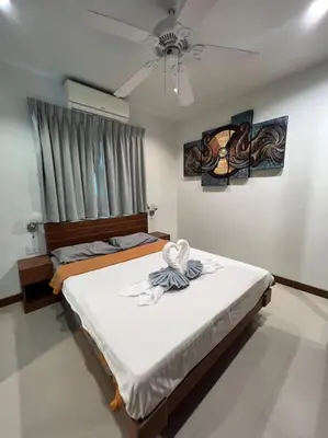 a bedroom with two beds and a ceiling fan at Stunning 4-BR House with Inviting Swimming Pool in Kamala Beach