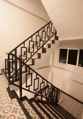 a spiral staircase in a house with a carpet at Nature Pine Phuket เนเชอร์ไพน์ภูเก็ต in Rawai Beach