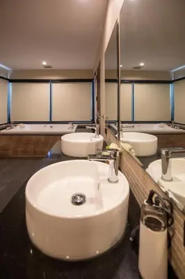 a bathroom with three sinks and two mirrors at Phuket Superior Sunrise Sea View Private Pool Villa in Kata Beach