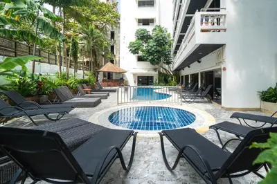 a patio with chairs and a swimming pool at Patong Central Residence & Apartment in Patong Beach