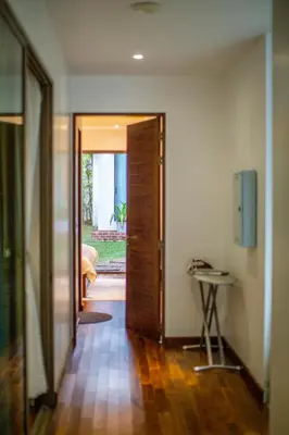 a hallway with a door open to a room with a table at Phuket Boutique Pool Villa-79 in Rawai Beach