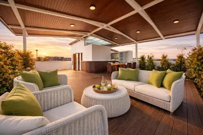 a patio with couches and a table on a deck at 4BR Penthouse Royal Marina 6B Private Rooftop Pool with 360 View in Phuket Town