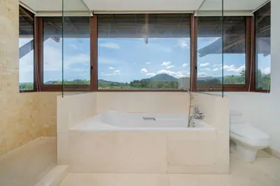a bathroom with a tub and a toilet and a window at 4BR Penthouse Royal Marina 6B Private Rooftop Pool with 360 View in Phuket Town