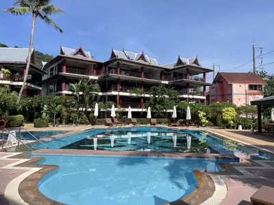 a large swimming pool in front of a building at Peaceful retreat at Kalim Bay - pool bar garden in Patong Beach