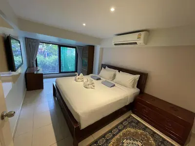 a bedroom with a bed with two stuffed animals on it at Peaceful retreat at Kalim Bay - pool bar garden in Patong Beach