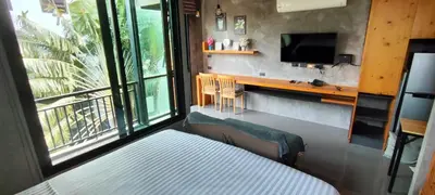 a bedroom with a bed and a tv and a window at Relife SPB in Phuket Town