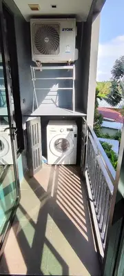 a washing machine on the balcony of a house at Relife SPB in Phuket Town
