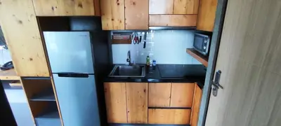 a small kitchen with a sink and a refrigerator at Relife SPB in Phuket Town