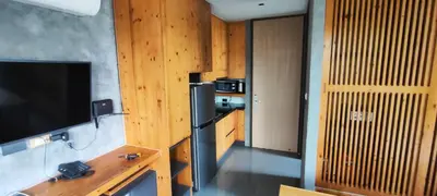 a kitchen with a black refrigerator and a television at Relife SPB in Phuket Town