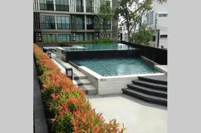 a swimming pool in front of a building at At Laguna at Zcape Condo in Bang Tao Beach