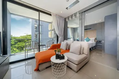 a living room with a couch and a bed at Modern Tropical Kamala Beach in Phuket Town