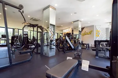 a gym with treadmills and elliptical machines at Modern Tropical Kamala Beach in Phuket Town
