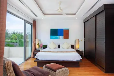 a bedroom with a bed and a large window at The Residence Villa 203 in Bang Tao Beach