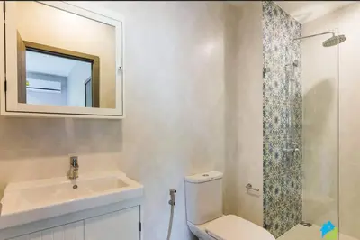 a bathroom with a toilet and a sink and a mirror at 2 Bedroom Apartment in Naiyang - The Title Residences, Naiyang in Nai Yang Beach
