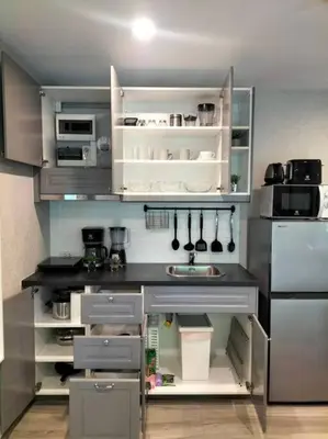 a kitchen with white cabinets and a counter top at 2 Bedroom Apartment in Naiyang - The Title Residences, Naiyang in Nai Yang Beach