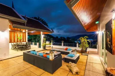 an outdoor patio with couches and a table at Kinnaree Grand Villa - pool, panoramic views, maid in Kamala Beach