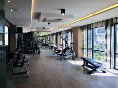 a gym with several treadmills and exercise bikes at Aristo Resort Surin Beach M18 in Phuket Town