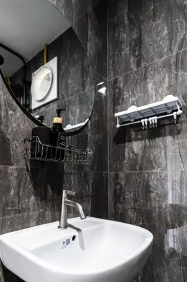 a bathroom with a sink and a mirror at Apollo Hotel Chalong in Ban Suan