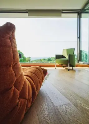 a living room with a couch and chairs and a large window at Bluepoint SeaView Retreat Patong in Patong Beach