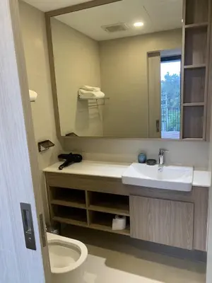a bathroom with a sink and a toilet and a mirror at Apartments in Skypark Laguna Bang Tao in Bang Tao Beach