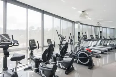 a gym with a row of treadmills and exercise bikes at Kamala Beach P73 Exclusive Junior Suite in Kamala Beach